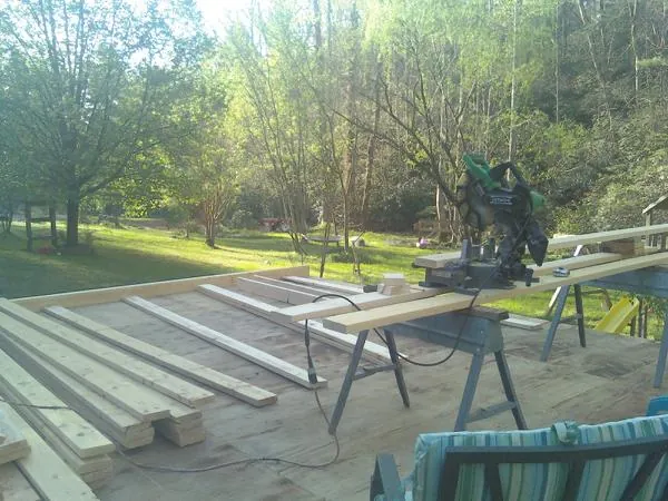 Miter saw and framing lumber on a deck under construction in Snoqualmie Pass